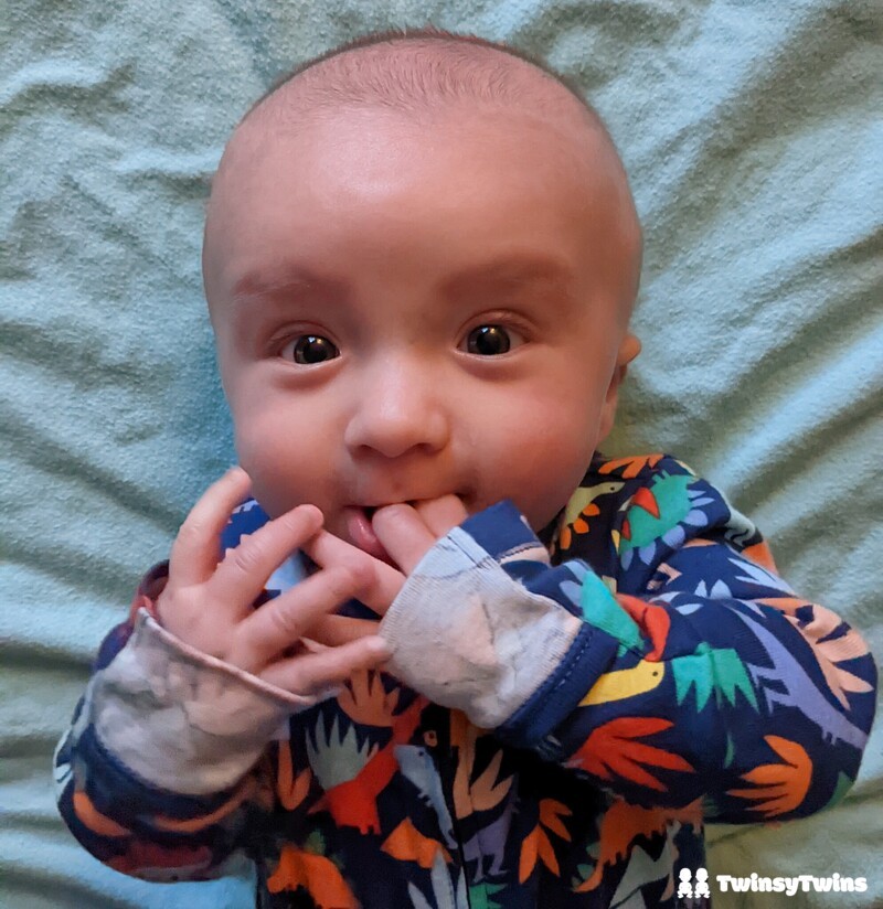 Chewing fingers, a classic sign teething has begun!