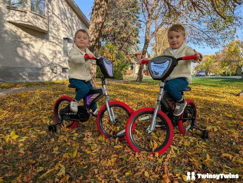 Huffy Bikes Electro Light Bicycle Twin Toddlers Sitting On Bikes With Autumn Leaves Smiling