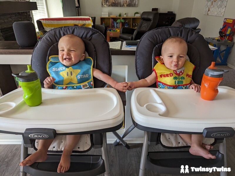 Mario Day Twin Babies Holding Hands Wearing Nintendo Bibs